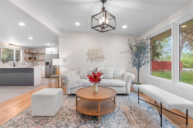 a living room with furniture and a chandelier