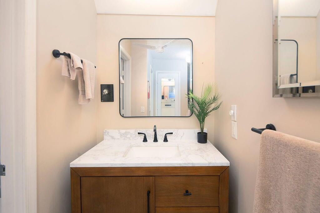 4600 Wildwood Tree Lane, Unit A Boynton Beach, FL 33436 - Photo 11 of 30 a bathroom with a sink vanity and a mirror