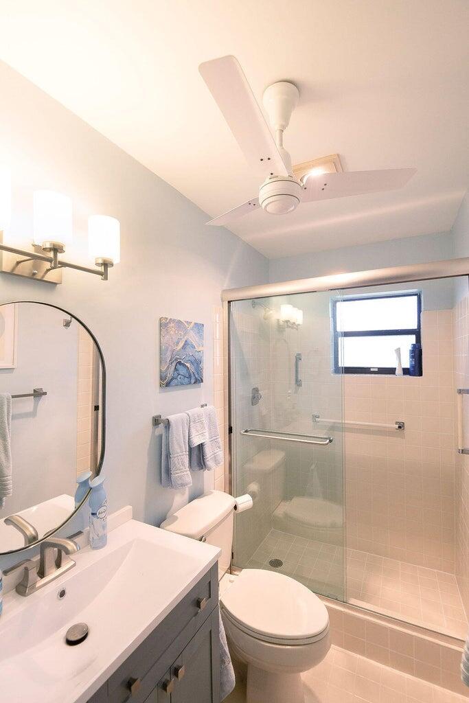 4600 Wildwood Tree Lane, Unit A Boynton Beach, FL 33436 - Photo 16 of 30 a bathroom with a sink a toilet and mirror