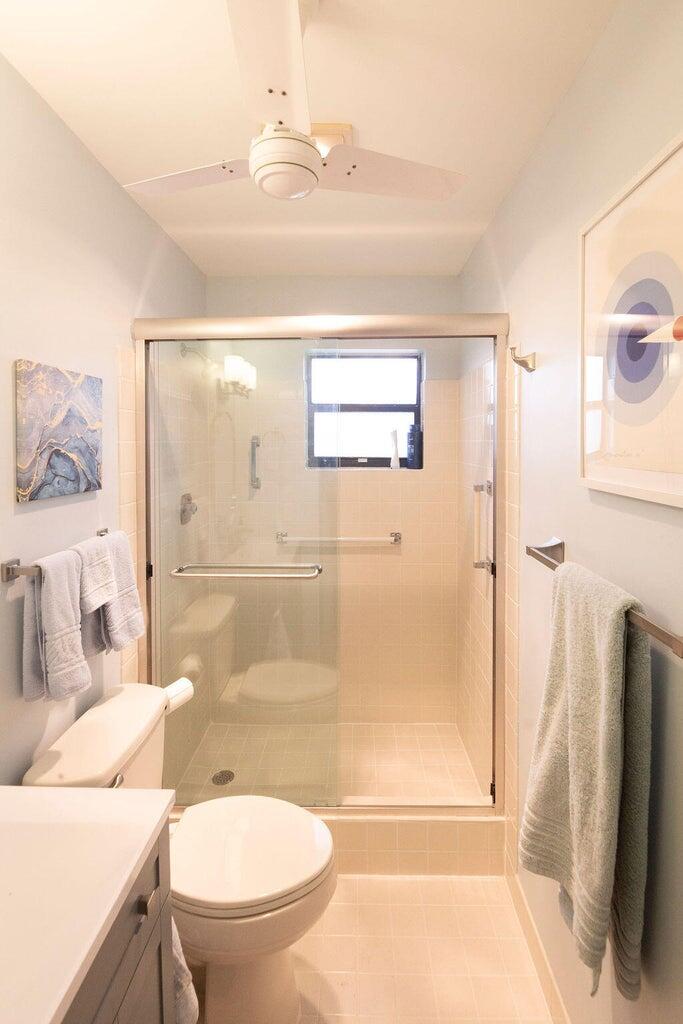 4600 Wildwood Tree Lane, Unit A Boynton Beach, FL 33436 - Photo 17 of 30 a bathroom with a sink toilet and shower