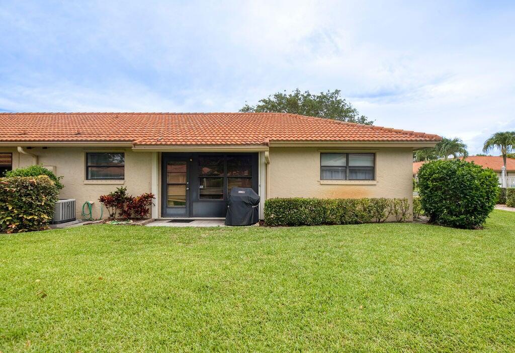 4600 Wildwood Tree Lane, Unit A Boynton Beach, FL 33436 - Photo 22 of 30 a view of a house with backyard porch and garden