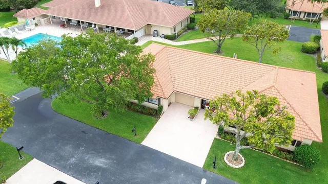 an aerial view of residential houses with outdoor space and street view
