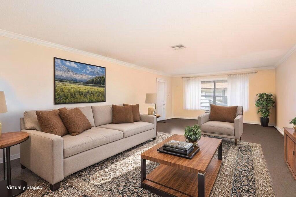 4600 Wildwood Tree Lane, Unit A Boynton Beach, FL 33436 - Photo 5 of 30 a living room with furniture and a large window