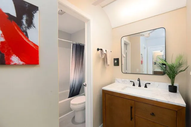 a view of bathroom with a toilet sink and mirror