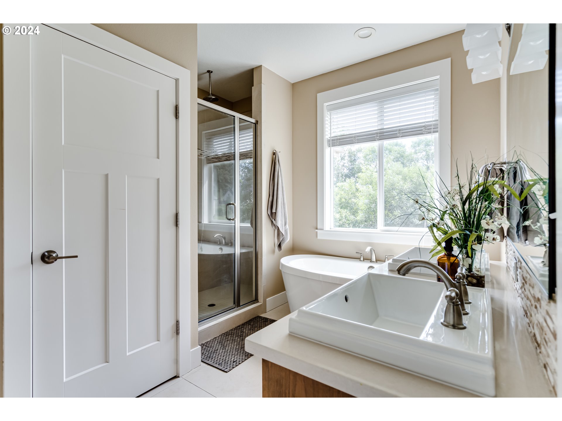 3278 Timberline Drive Eugene, OR 97405 - Photo 18 of 41 a bathroom with a sink a large mirror and a shower