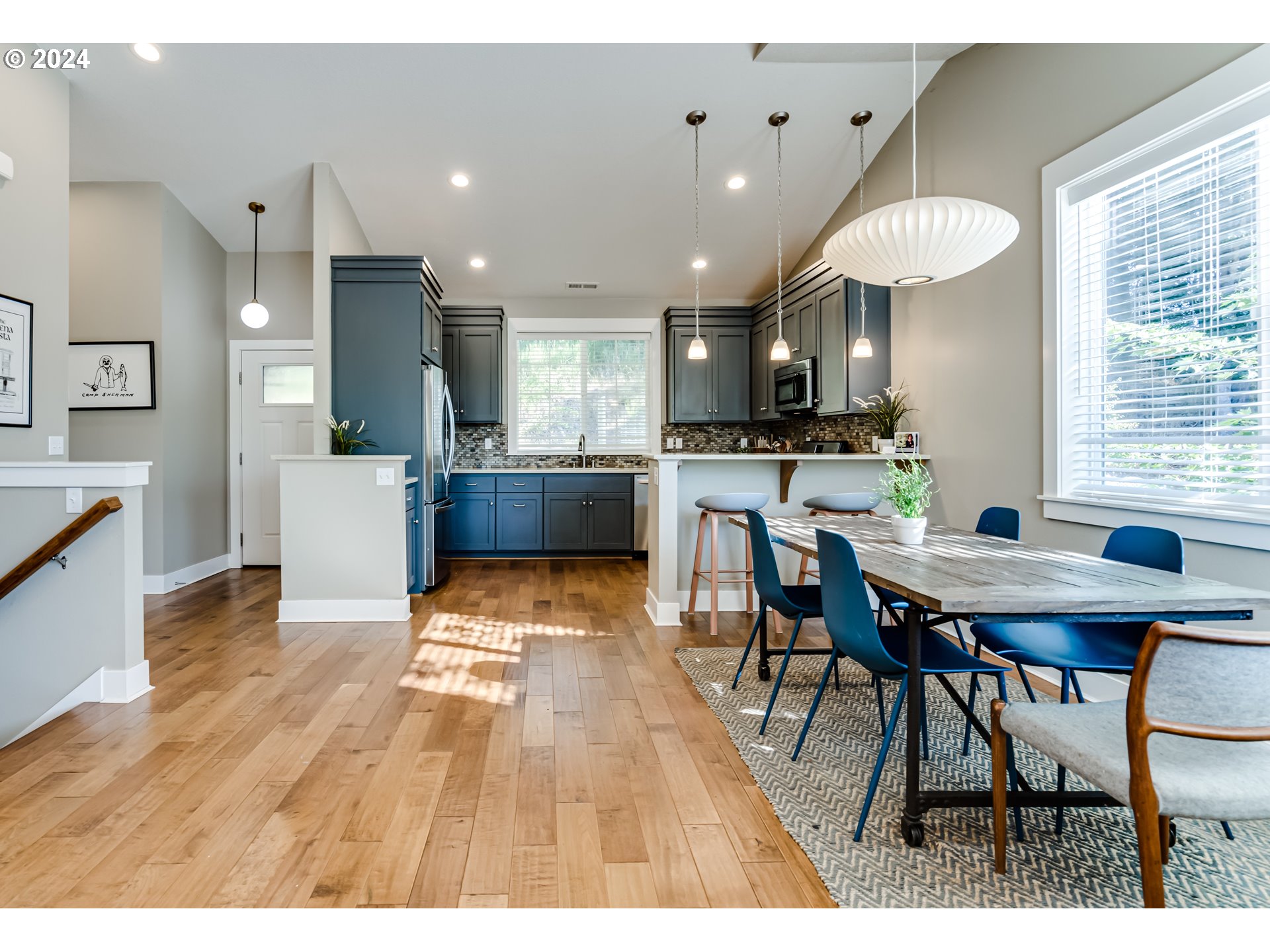 3278 Timberline Drive Eugene, OR 97405 - Photo 3 of 41 a dining hall with stainless steel appliances kitchen island a table and chairs in it