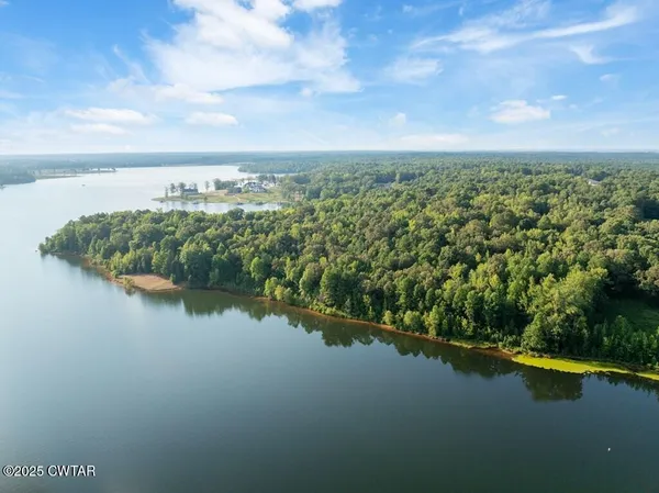 a view of a lake with a yard