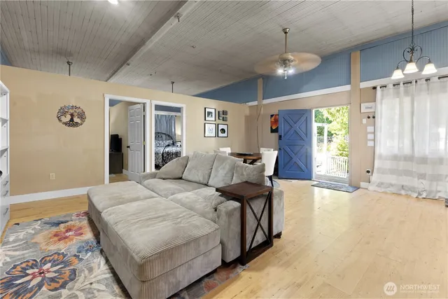 a spacious bedroom with a bed and a chandelier