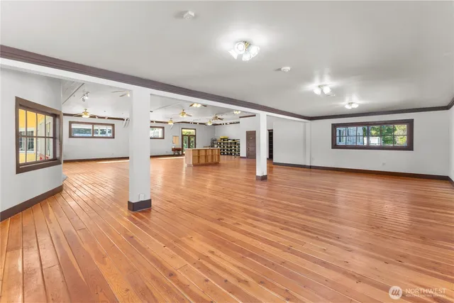 a view of empty room with wooden floor