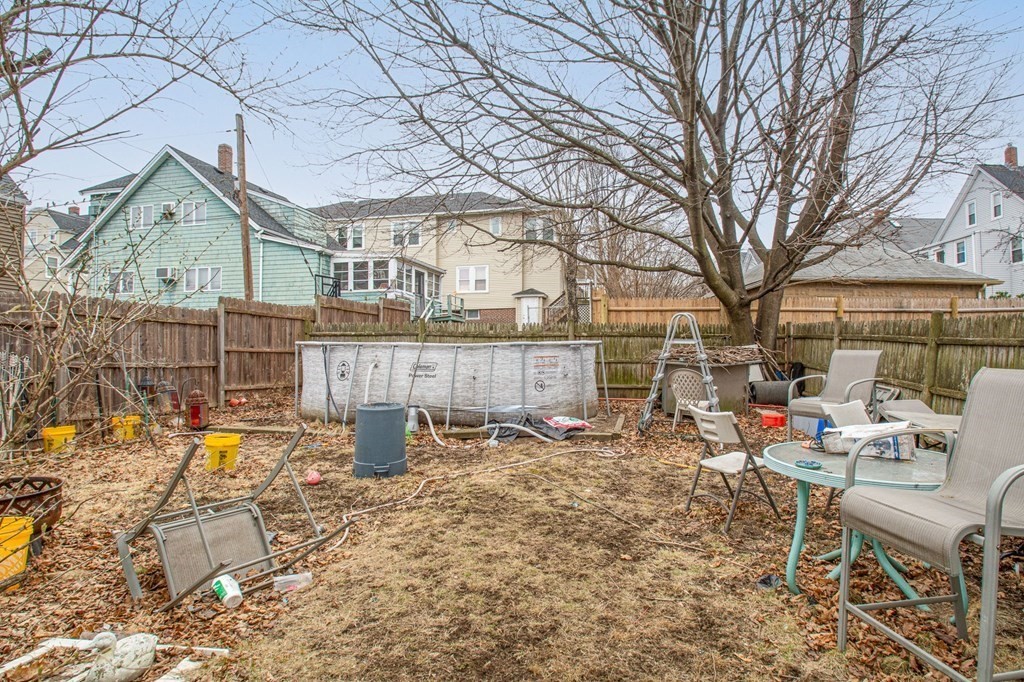 823 Broadway Everett, MA 02149 - Photo 15 of 16 a backyard of a house with barbeque oven table and chairs