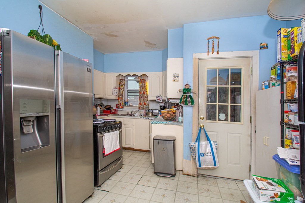 823 Broadway Everett, MA 02149 - Photo 3 of 16 a kitchen with stainless steel appliances granite countertop a refrigerator and a stove