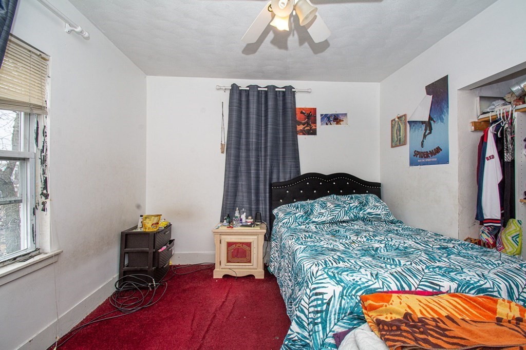 823 Broadway Everett, MA 02149 - Photo 6 of 16 a bedroom with a bed and a window