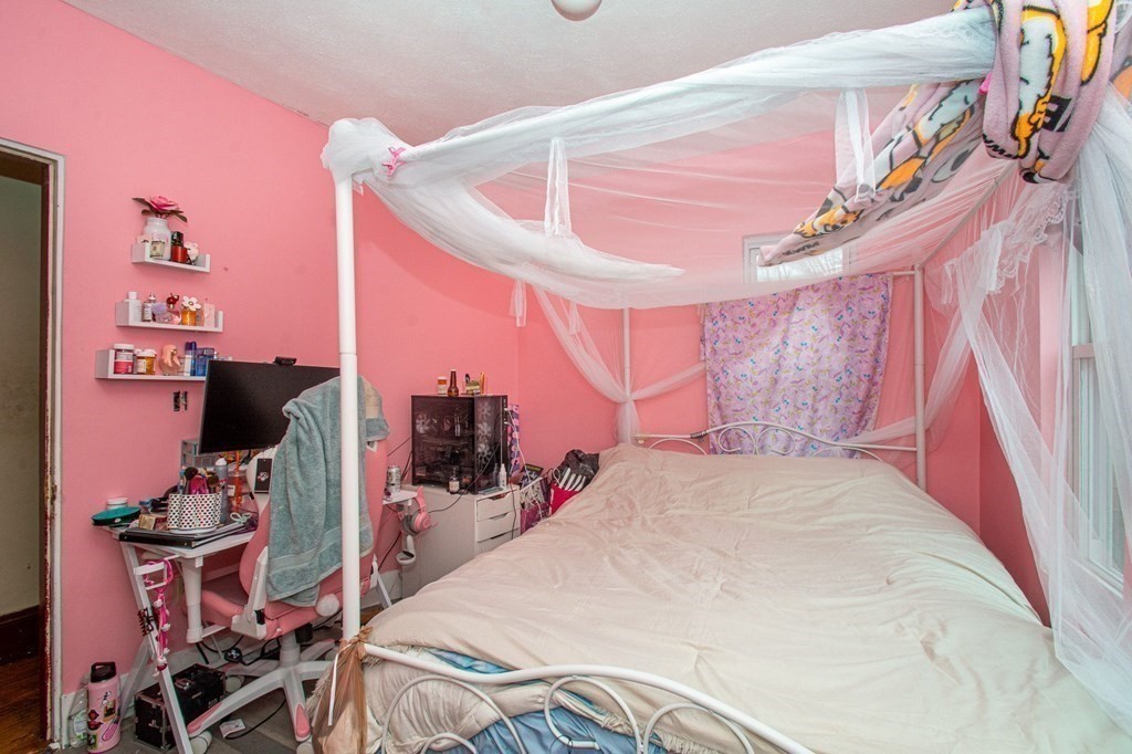 823 Broadway Everett, MA 02149 - Photo 8 of 16 a bed room with a bed and a tv