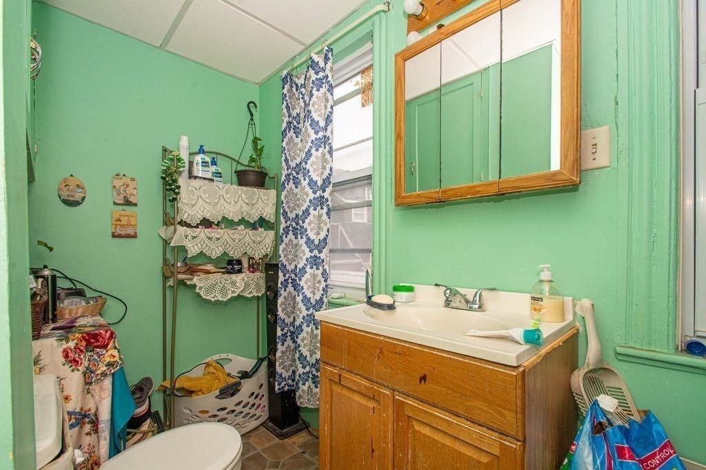 823 Broadway Everett, MA 02149 - Photo 9 of 16 a bathroom with a sink and a mirror