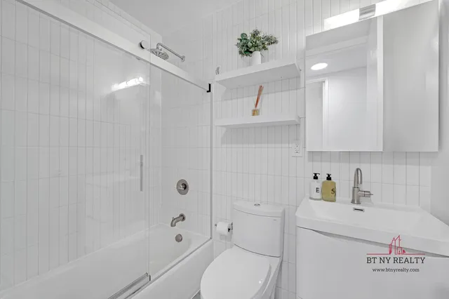 a view of an empty room with a fireplace and a rug