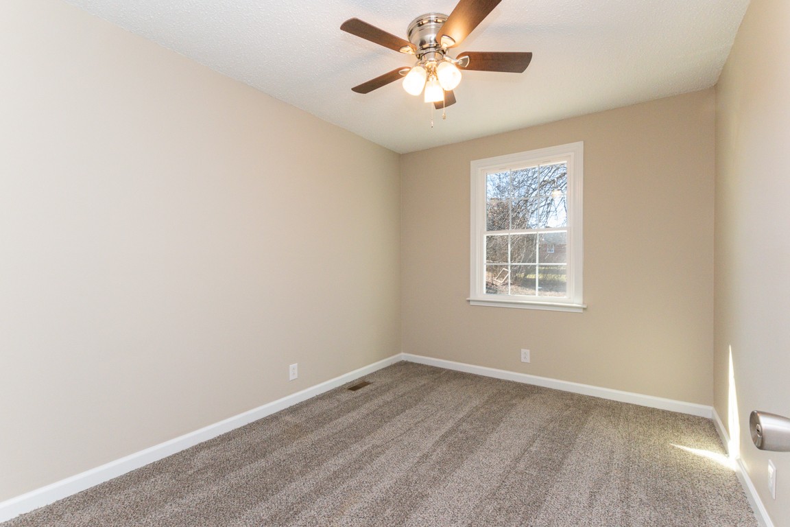 816 Garrettsburg Road Clarksville, TN 37042 - Photo 16 of 34 an empty room with windows and fan