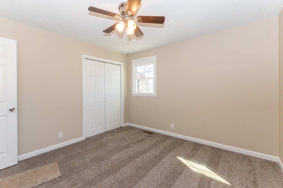 816 Garrettsburg Road Clarksville, TN 37042 - Photo 19 of 34 an empty room with windows and fan