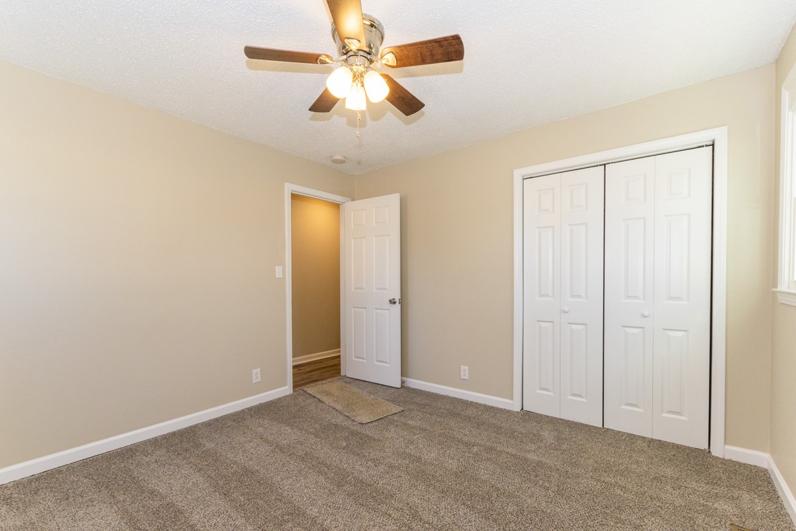 816 Garrettsburg Road Clarksville, TN 37042 - Photo 20 of 34 an empty room with closet and a chandelier fan