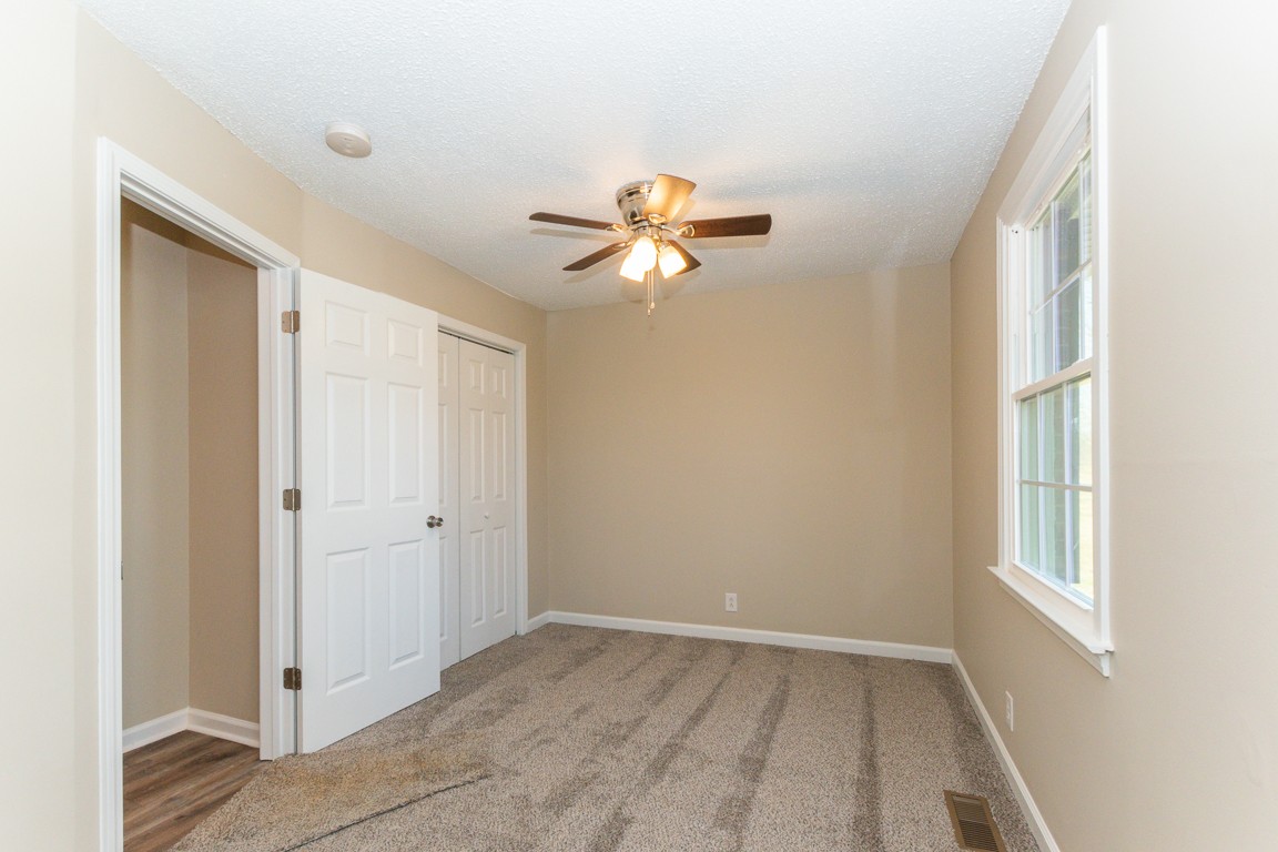 816 Garrettsburg Road Clarksville, TN 37042 - Photo 21 of 34 a view of an empty room with a window and a ceiling fan