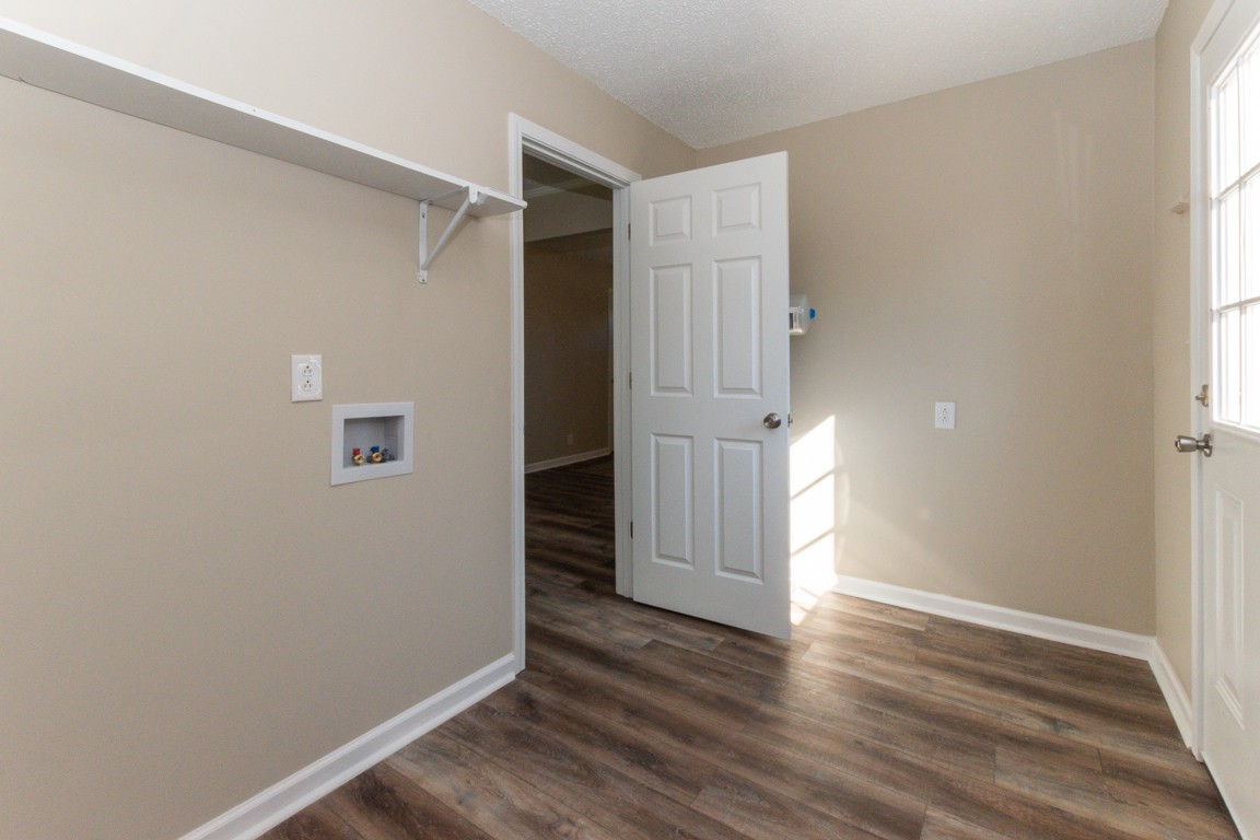 816 Garrettsburg Road Clarksville, TN 37042 - Photo 28 of 34 an empty room with wooden floor and windows