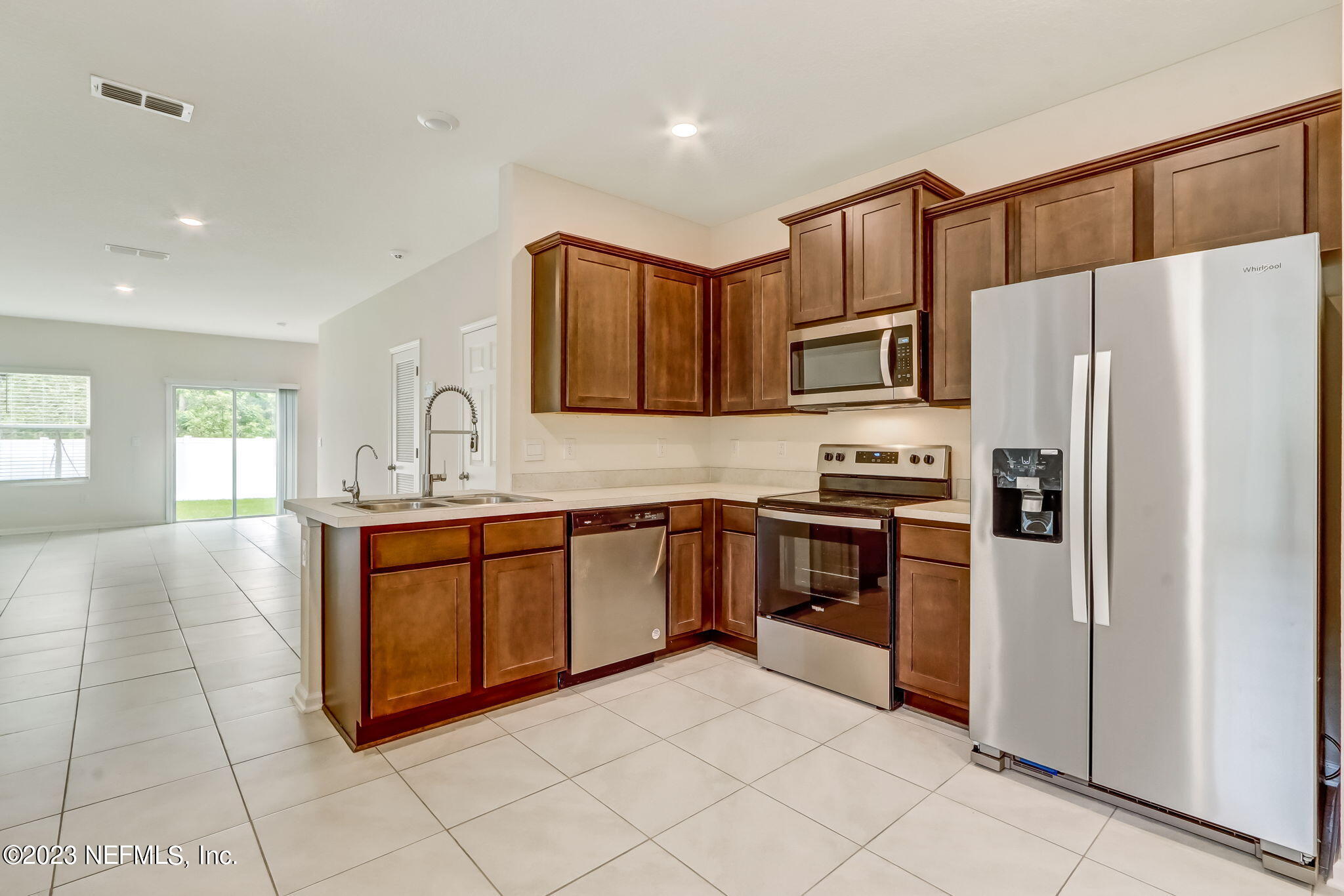 832 Observatory Parkway Jacksonville, FL 32218 - Photo 10 of 27 a kitchen with granite countertop a refrigerator and a stove top oven