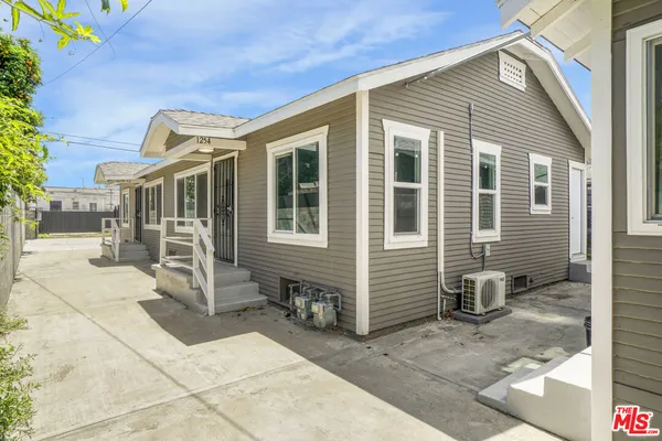 a front view of a house with a chair and glass door