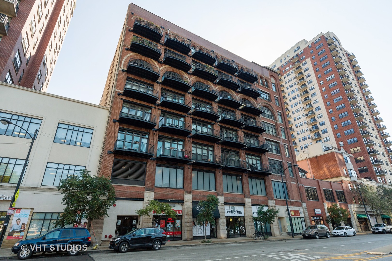 1503 South State Street, Unit 813 Chicago, IL 60605 - Photo 1 of 11 a front view of a building with lot of cars and trees