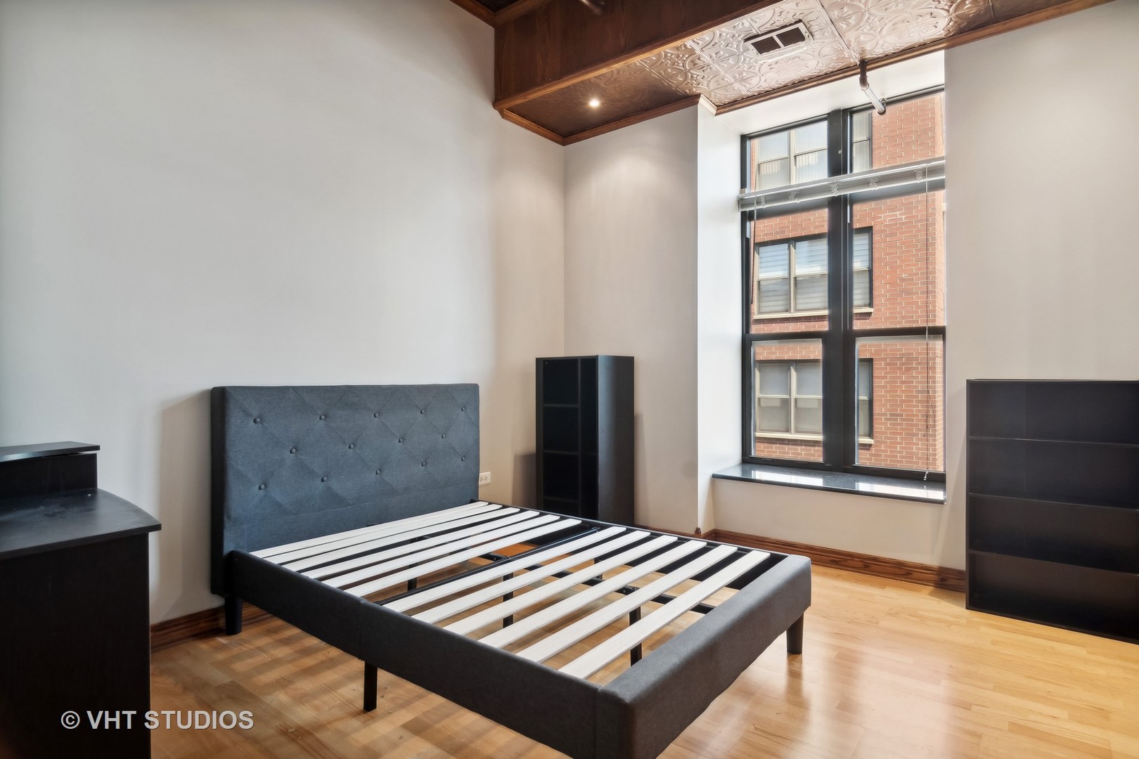 1503 South State Street, Unit 813 Chicago, IL 60605 - Photo 6 of 11 a bedroom with a bed and a window
