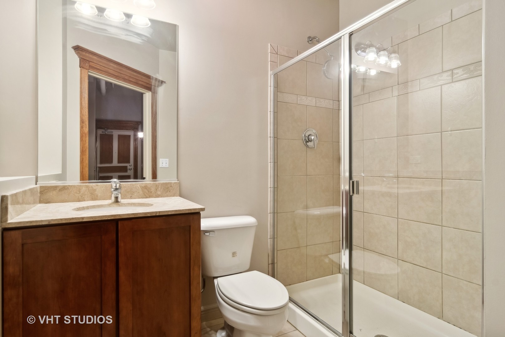 1503 South State Street, Unit 813 Chicago, IL 60605 - Photo 7 of 11 a bathroom with a sink a toilet and shower
