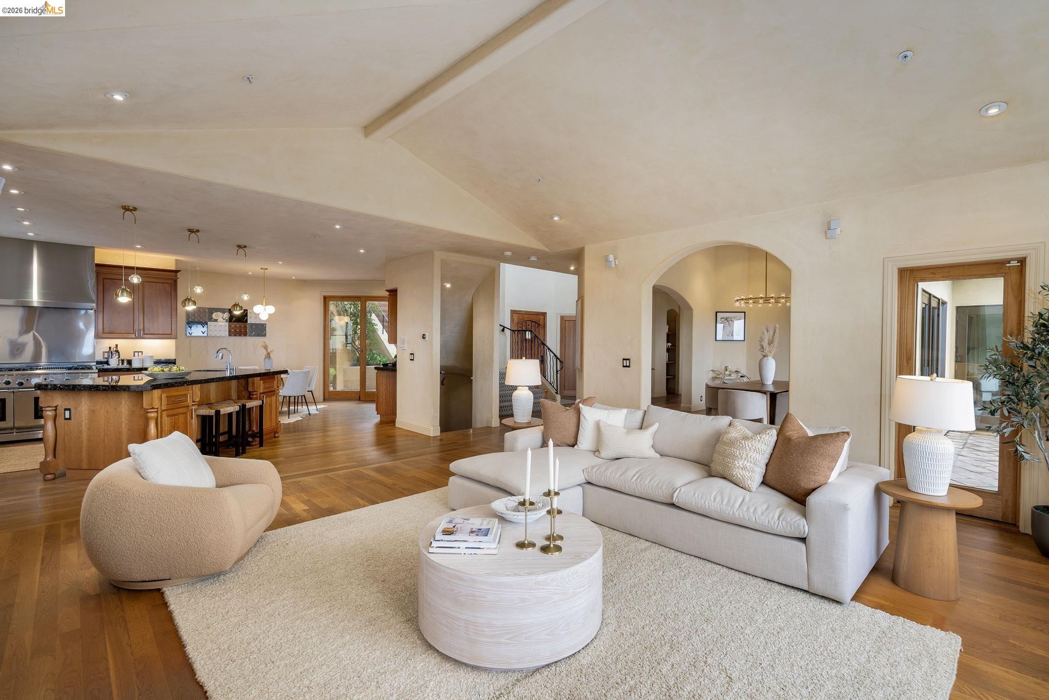 6257 Virgo Road Oakland, CA 94611 - Photo 15 of 60 Living room featuring light wood finished floors, recessed lighting, arched walkways, and stairway