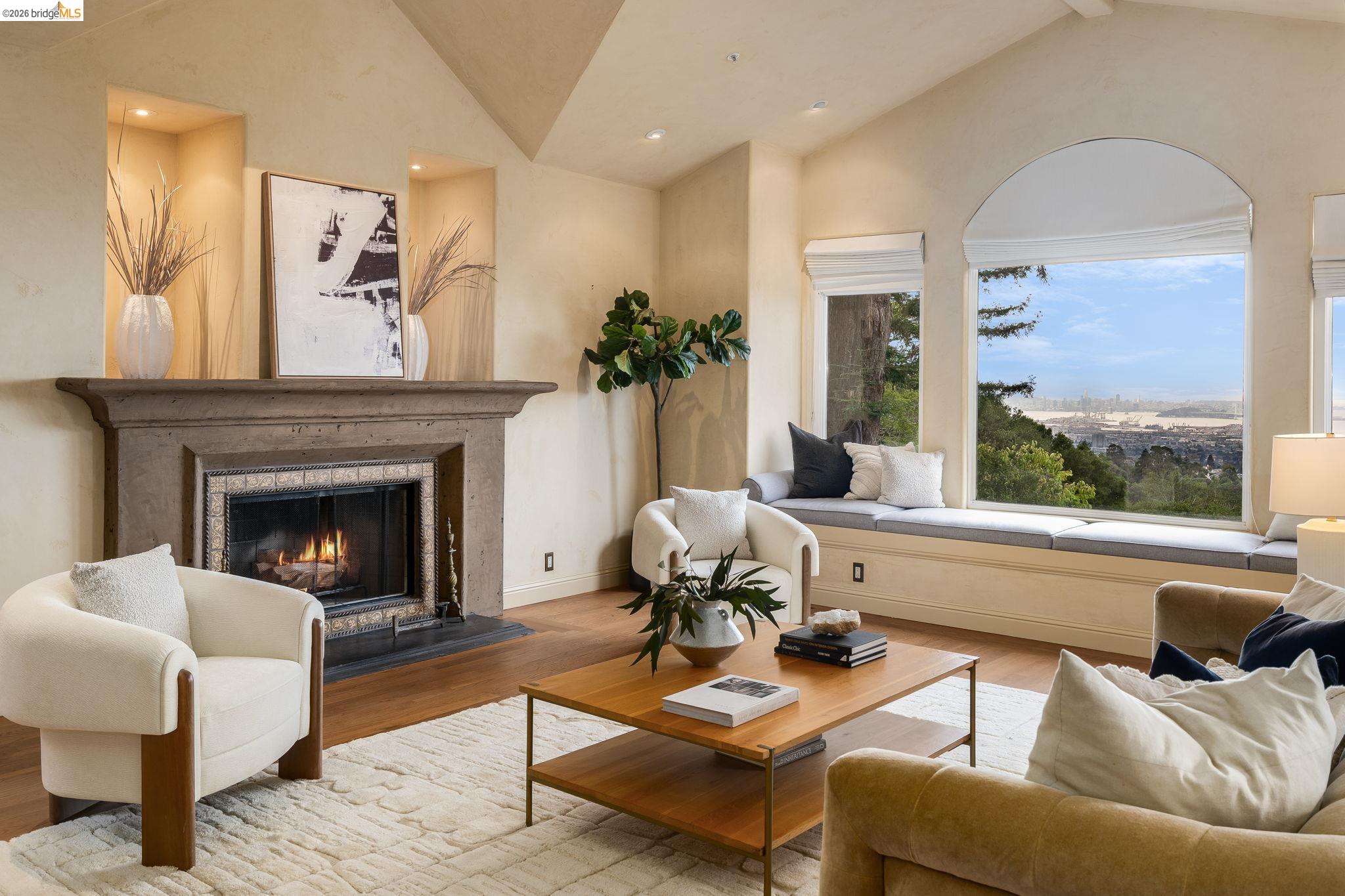 6257 Virgo Road Oakland, CA 94611 - Photo 7 of 60 Living area featuring wood finished floors, a warm lit fireplace, recessed lighting, and high vaulted ceiling