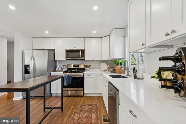 a kitchen with stainless steel appliances a refrigerator stove microwave and cabinets