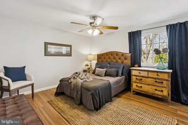 a view of a hallway with wooden floor and furniture