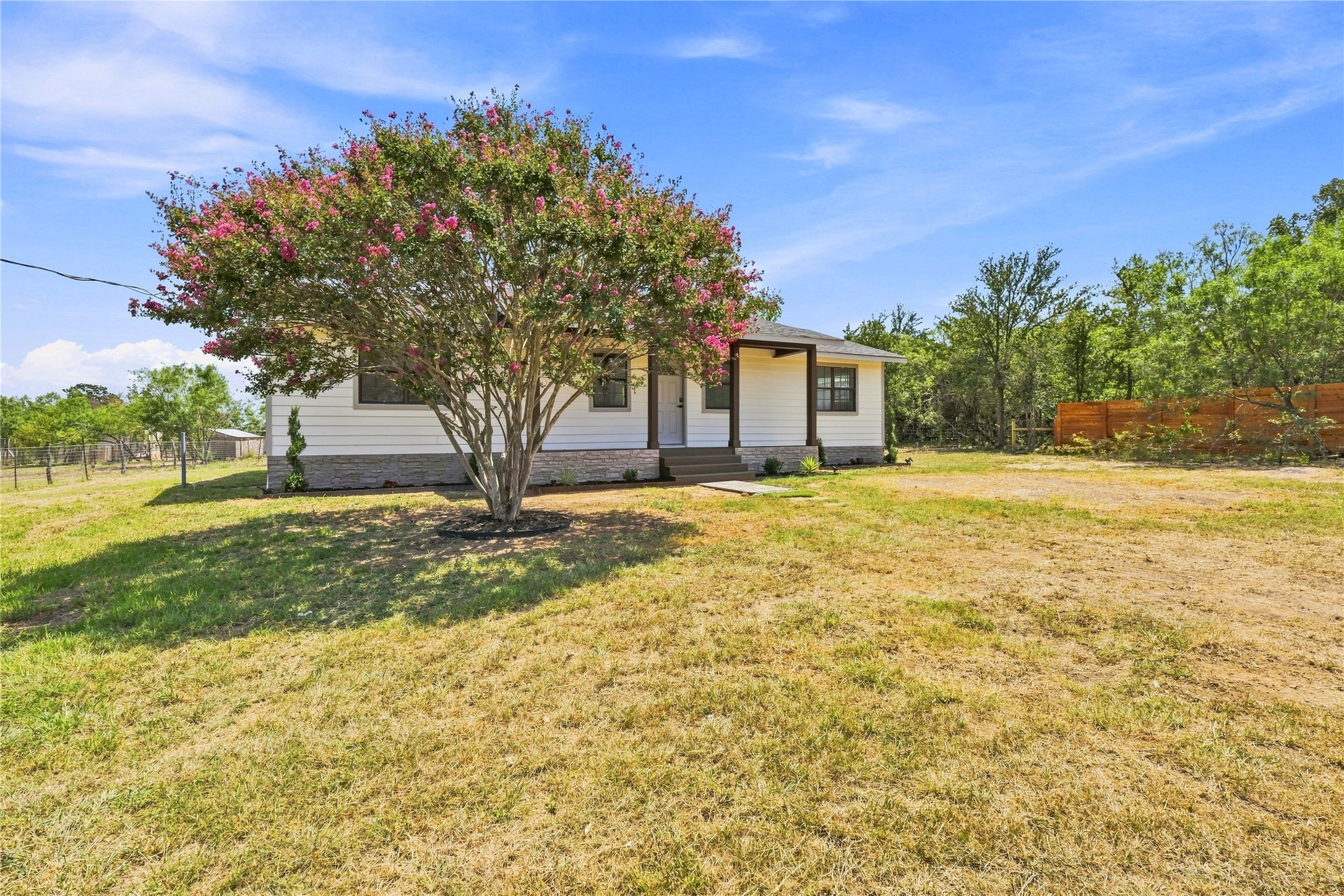 747 Chamberlin Road Dale, TX 78616 - Photo 2 of 28 A flowering crape myrtle graces the front of this charming single-story residence with a welcoming covered entry.