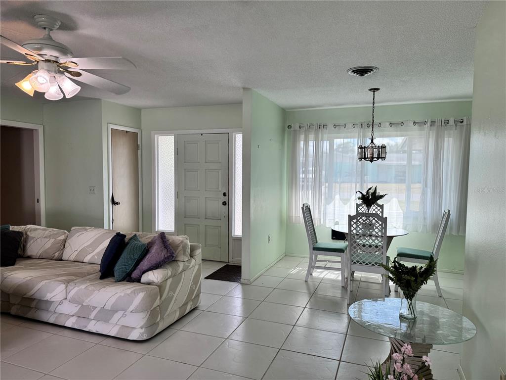 1048 Porpoise Road Venice, FL 34293 - Photo 12 of 26 a living room with furniture and a chandelier