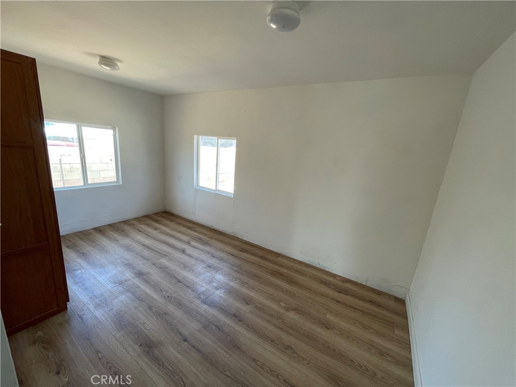 3005 Mary Street Riverside, CA 92506 - Photo 6 of 9 an empty room with wooden floor and windows