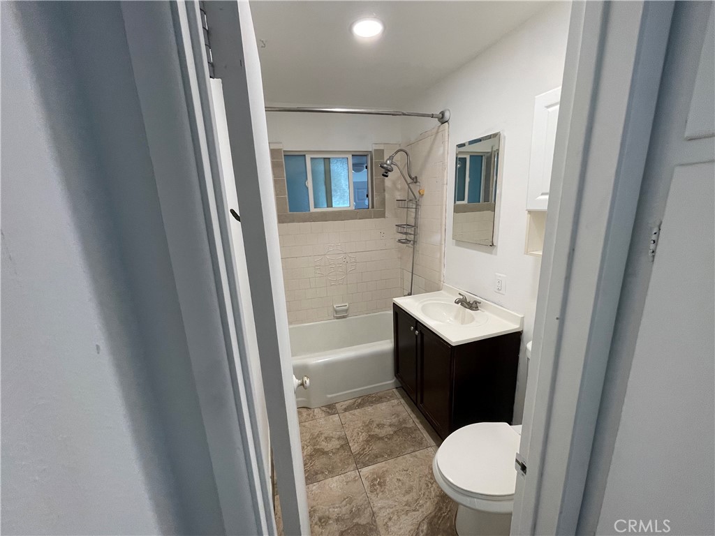 3005 Mary Street Riverside, CA 92506 - Photo 7 of 9 a bathroom with a toilet sink and mirror