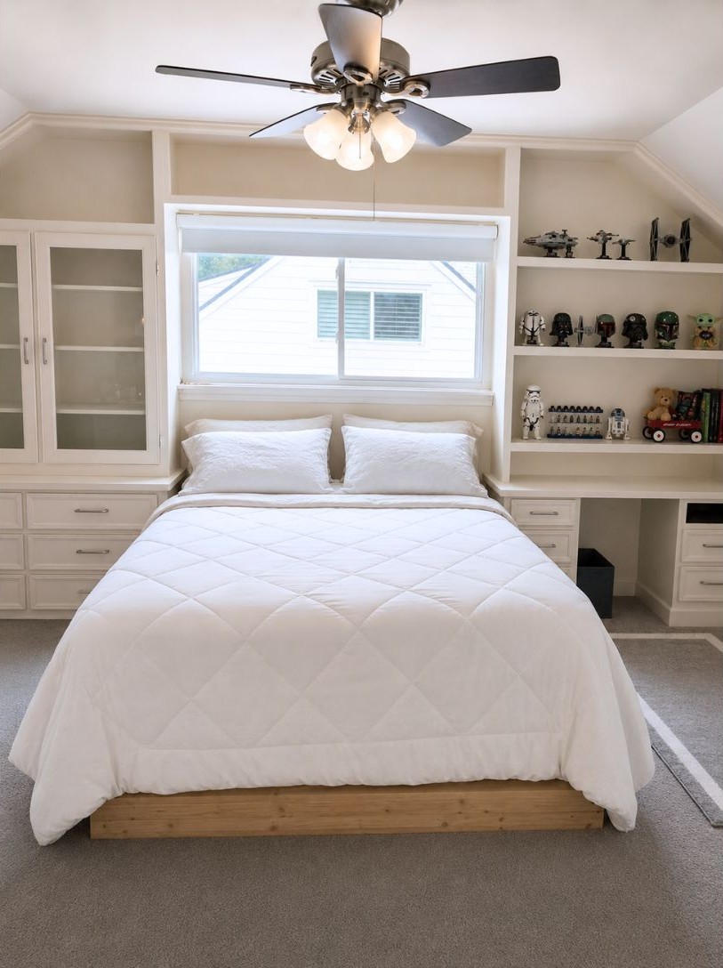13047 Taylorcrest Road Houston, TX 77079 - Photo 19 of 23 An upstairs secondary bedroom offers a comfortable retreat with custom built-in cabinetry & shelving, providing excellent storage & display space while maximizing functionality.
