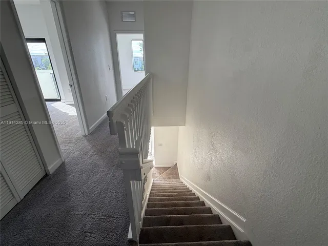 a view of a hallway with staircase