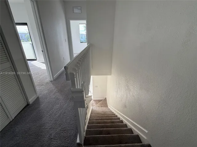 a view of a yard with wooden fences