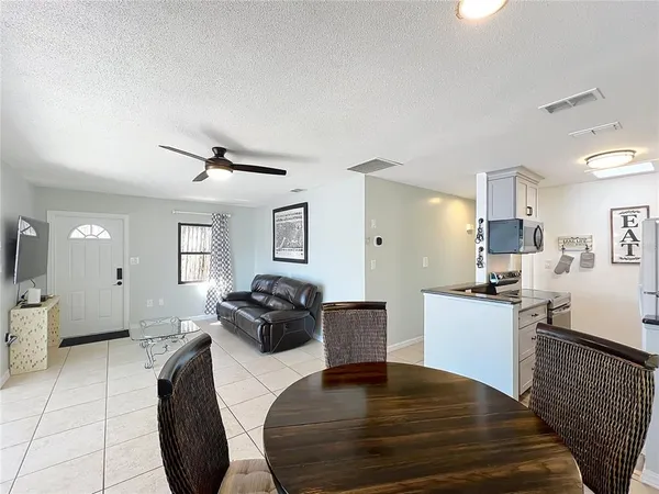 a kitchen with stainless steel appliances a refrigerator sink and white cabinets