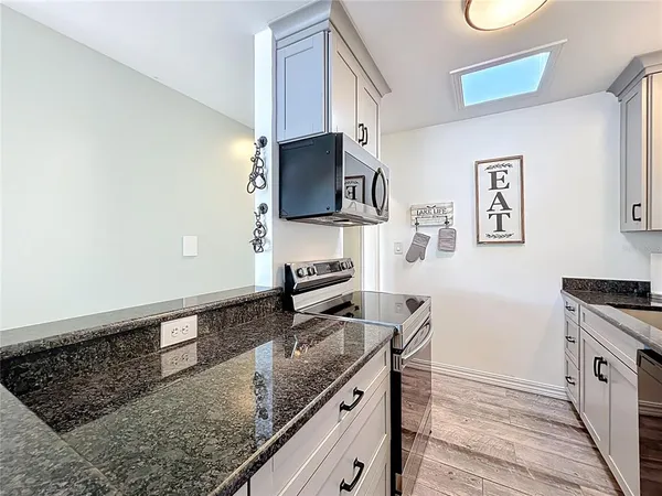 a kitchen with a table chairs and wooden floor