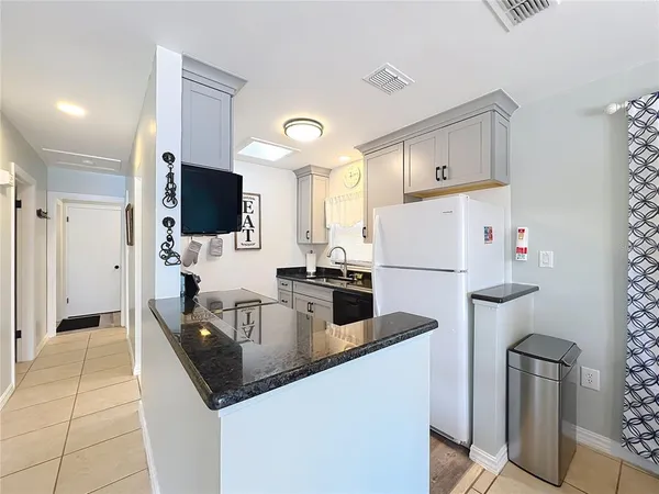 a kitchen with stainless steel appliances granite countertop a sink and cabinets