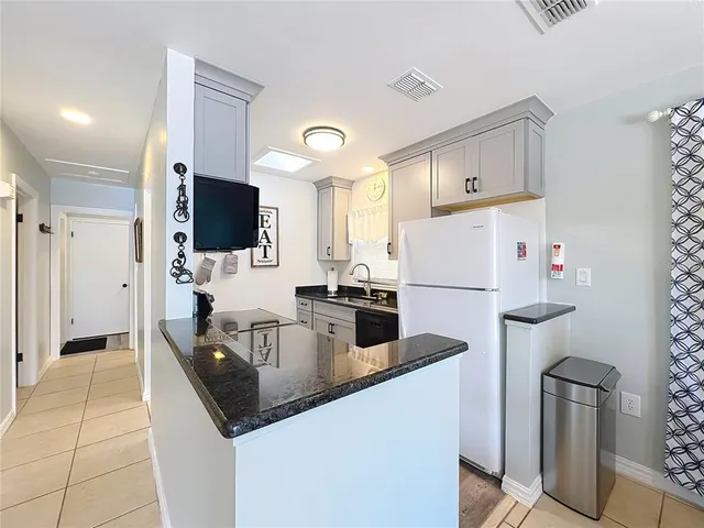 a kitchen with stainless steel appliances granite countertop a sink and cabinets