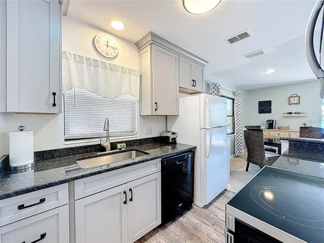 a living room with furniture and large windows