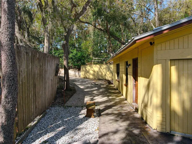 a view of a house with backyard and sitting area