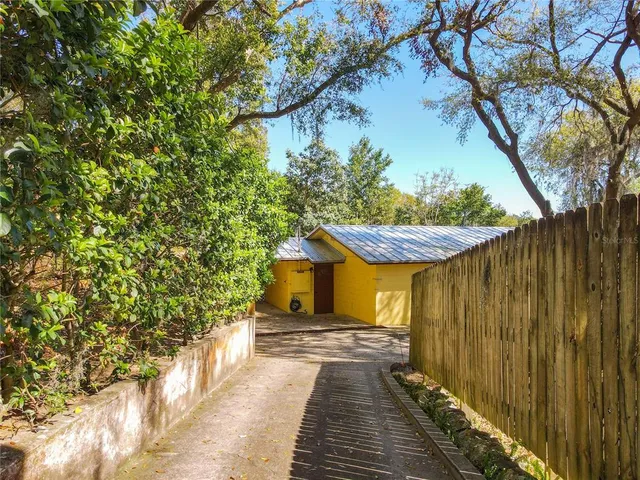 a view of a backyard with swimming pool