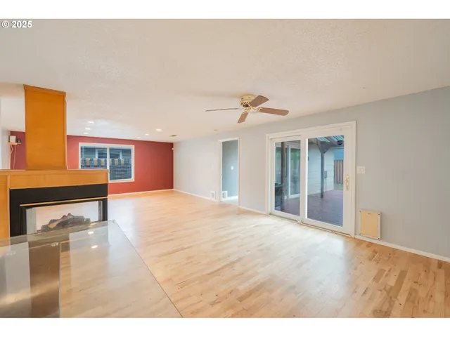 a view of an empty room with closet and a window