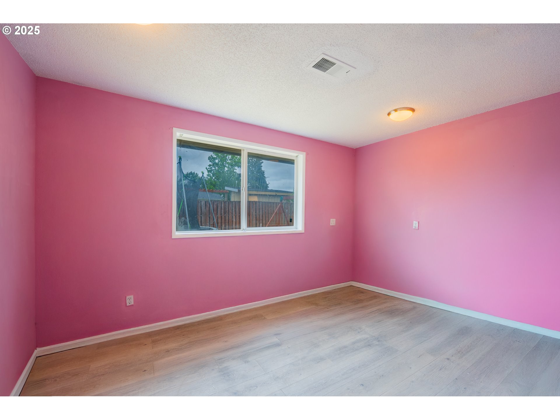 446 44th Avenue Southeast Salem, OR 97317 - Photo 19 of 37 an empty room with wooden floor and windows