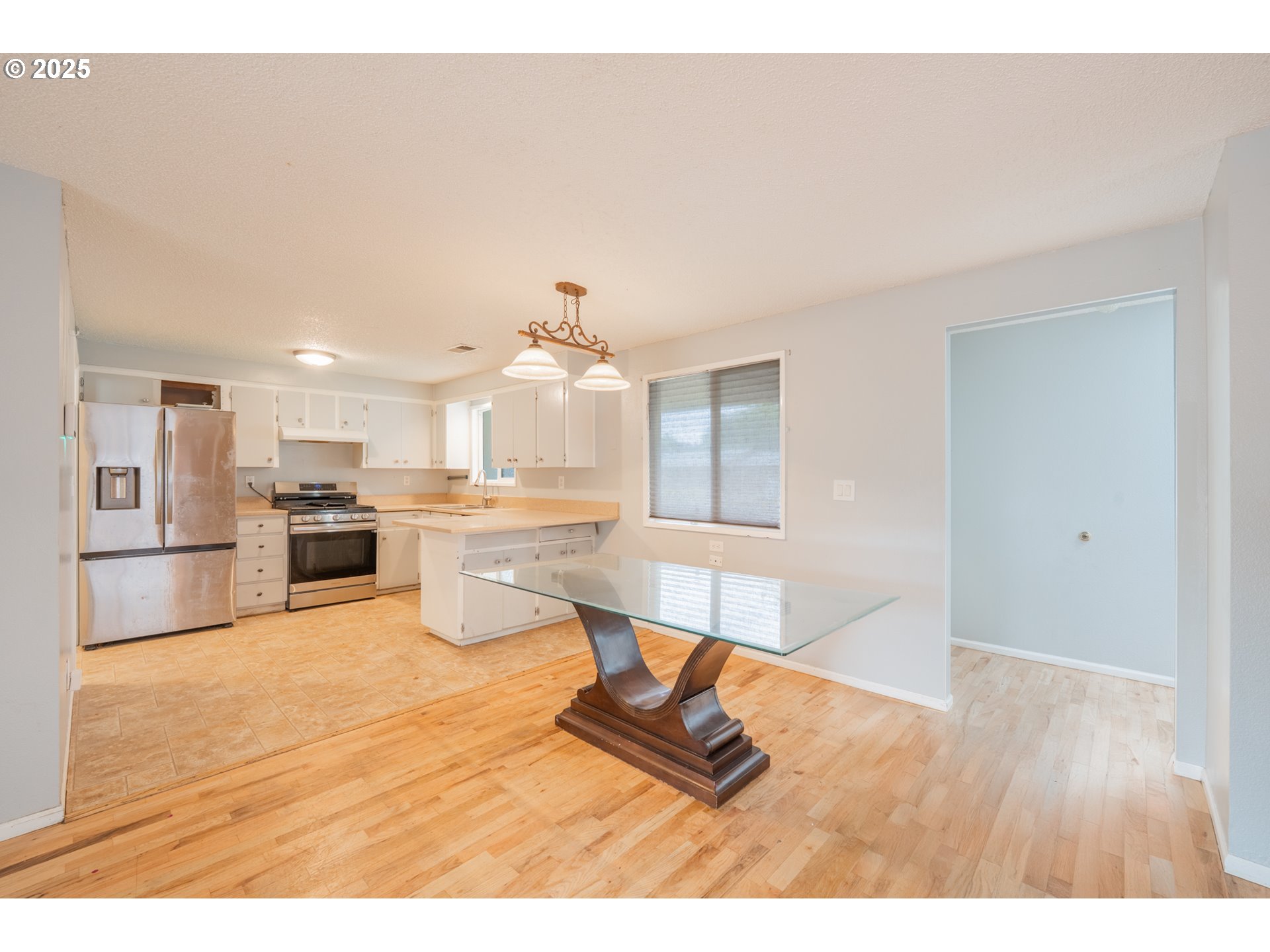 446 44th Avenue Southeast Salem, OR 97317 - Photo 9 of 37 a living room with furniture a kitchen view and appliances
